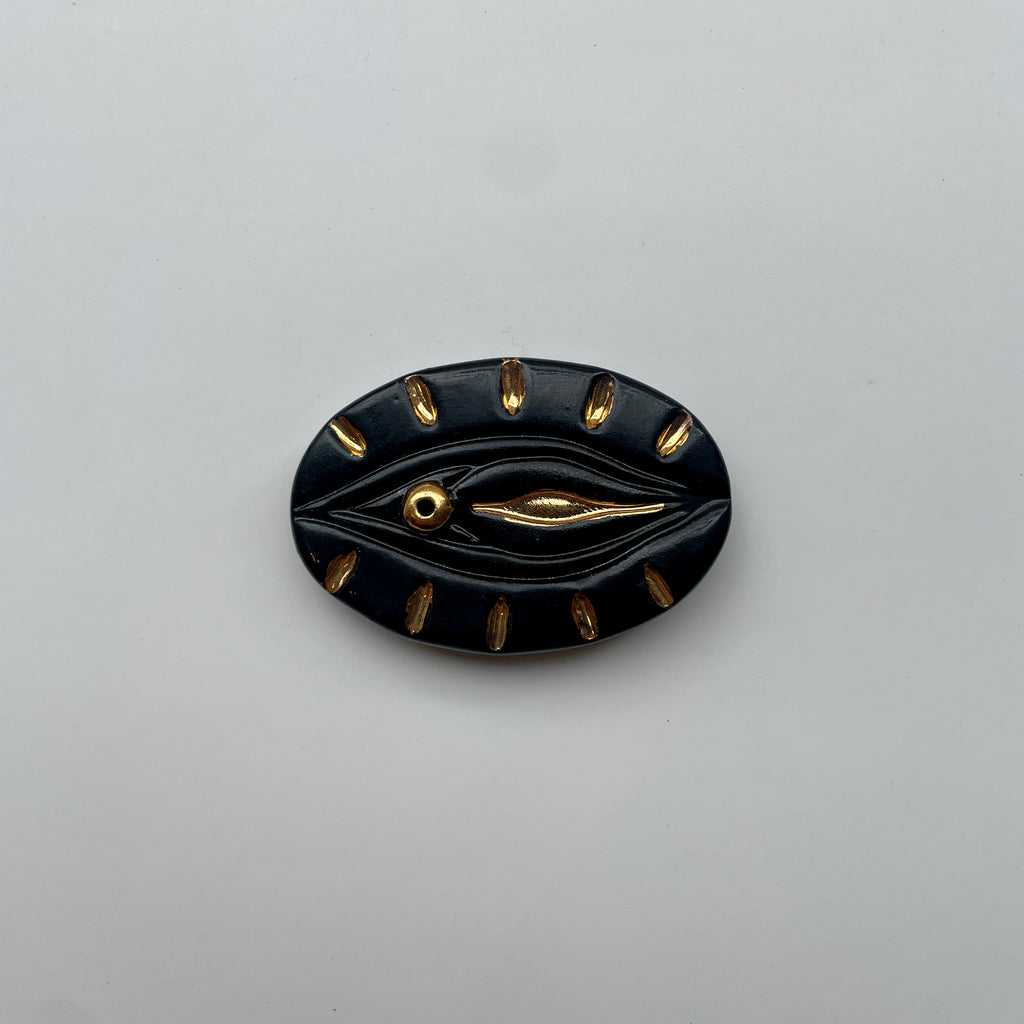 token moment yoni incense holder black gold burst ceramic vulva